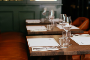 Clean dining tables with sparkling glasses and menus at a restaurant