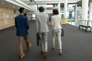 employees walking while interacting with each other in an office building