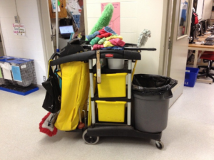A janitor cart containing cleaning equipment.