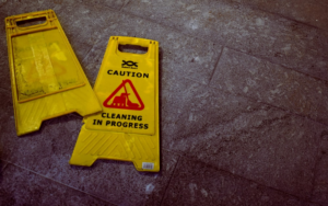 A caution sign stating cleaning in progress.