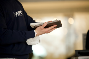 a person disinfecting an electronic device