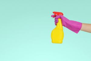 a person holding a yellow spray bottle