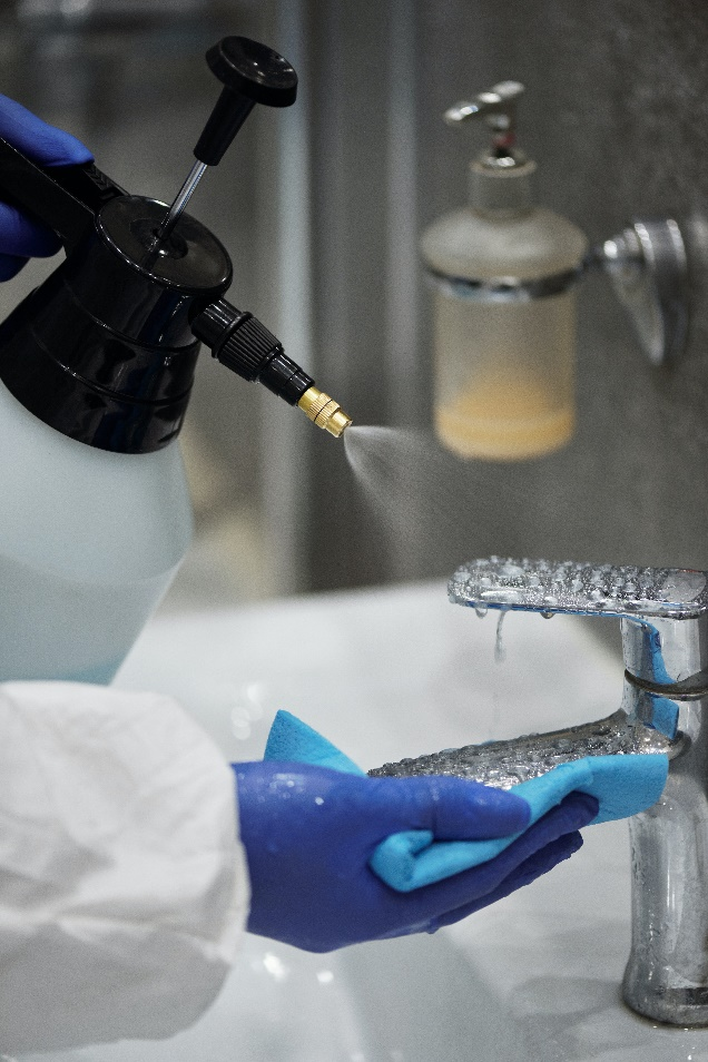 a person cleaning faucet